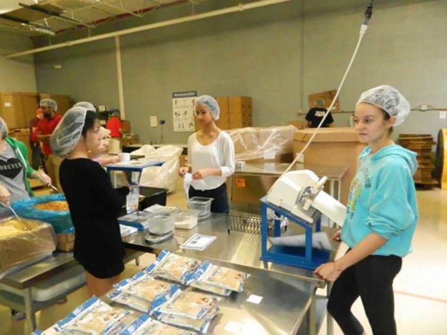 Students volunteer to work at Feed My Starving Childrens mobile program.