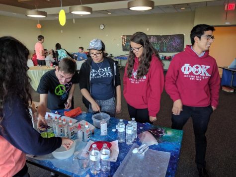 Members of Phi Theta Kappa help students with NASA themed activities at "Hooray Thursday."