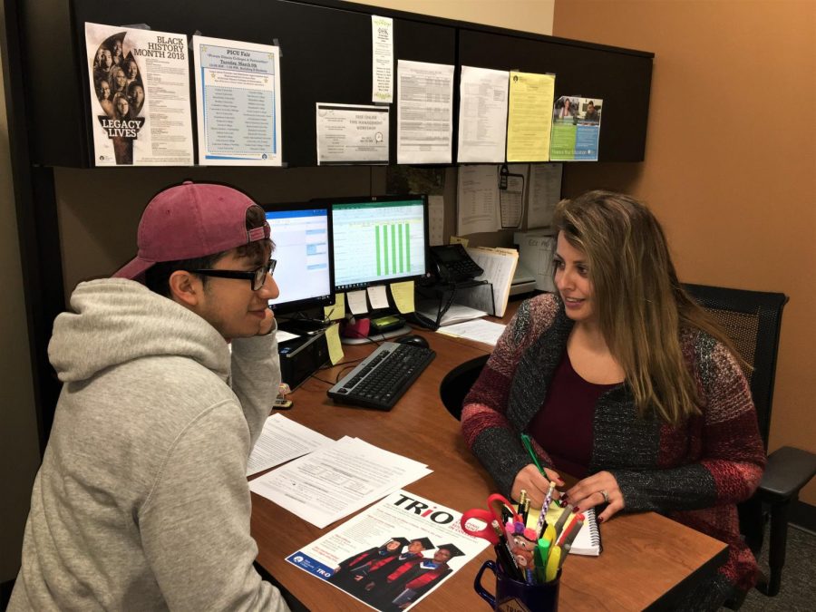 Maggie Im helping one of her students, Francisco Escobar, filling out FAFSA application. TRiO coordinators are fully committed to any students need.