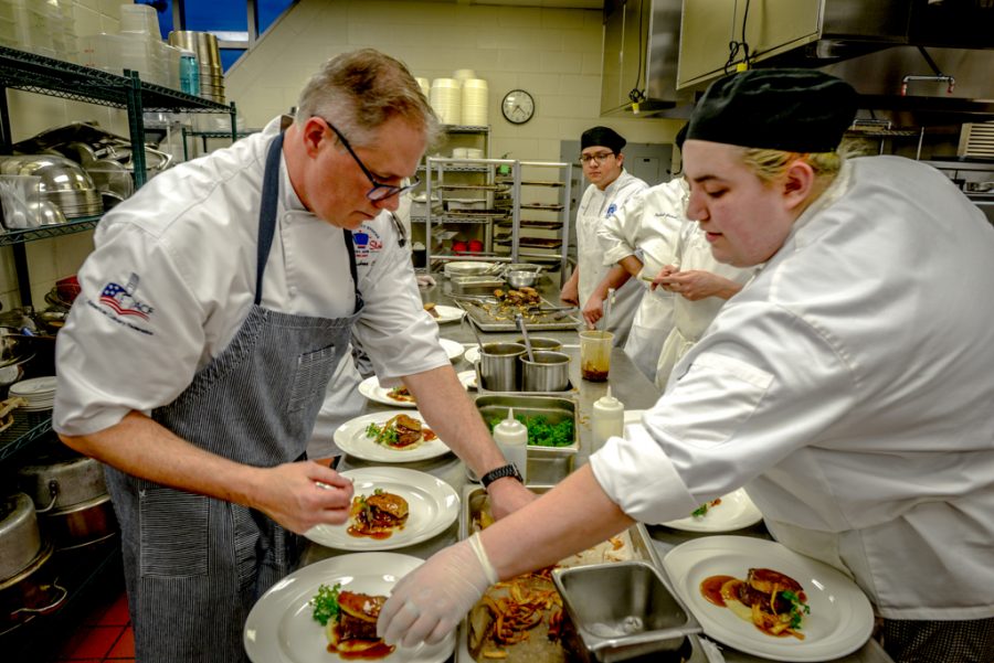 Chef Waidner works with the students on the Filet Mignon.