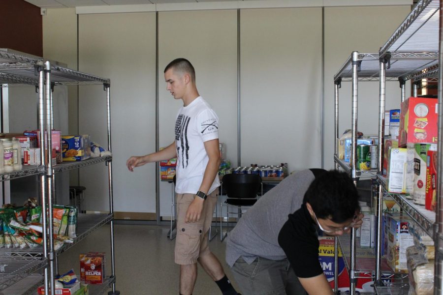 Jackson Wozniak, the Chair of PTK’s Vice President (left), and Emilio Edemni, Food Pantry co-officer (right) were reorganizing the food pantry that was recently expanded