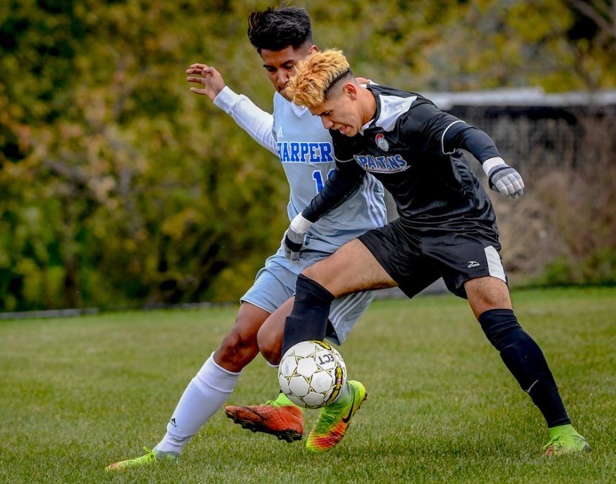 Aldo Lazaro attempts to maintain control of the ball during the Region 4 Championship game against Harper College