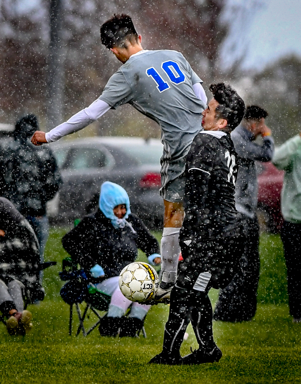 Action during the sunny, snowy,  and cold 1 to 0 loss in round one of the mens soccer tournament.