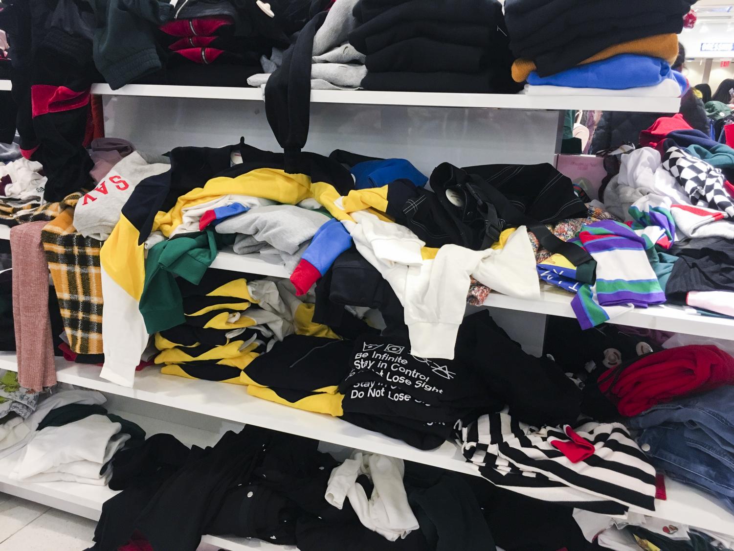 Shoppers fill up stores and rummage through clothes on Black Friday