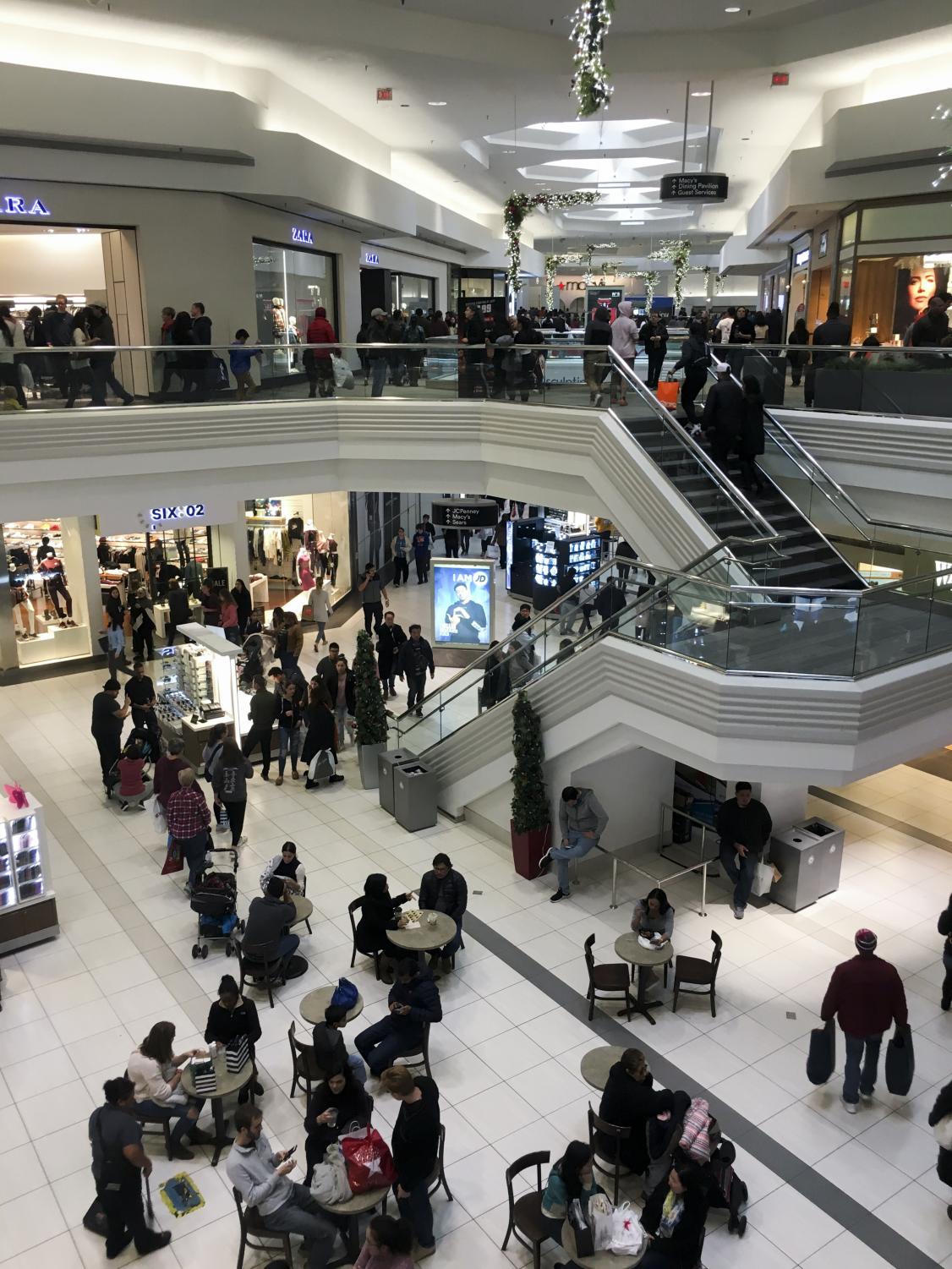 Shoppers fill up stores and rummage through clothes on Black Friday