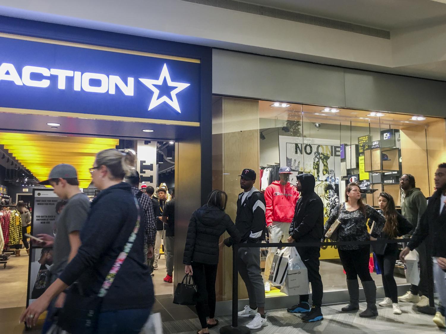 Shoppers fill up stores and rummage through clothes on Black Friday