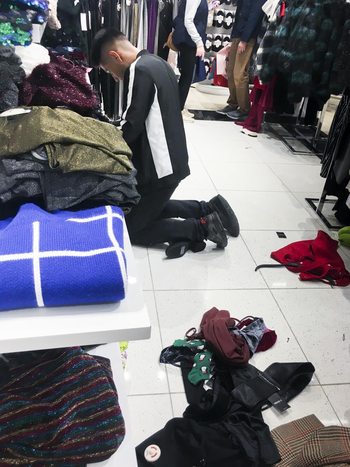 Shoppers fill up stores and rummage through clothes on Black Friday