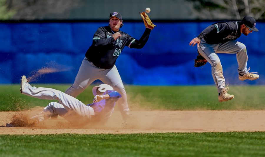 Action in ECCs  first game of the Saturday April 20, 2019 double header against the Praire State Pioneers. Jeremy Davis slides safely into second.