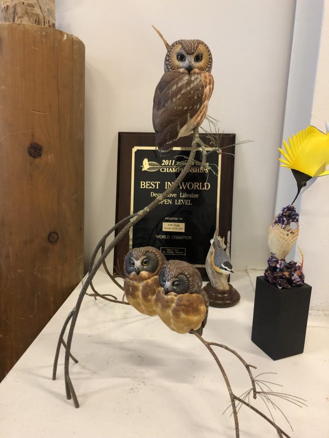 Josh Guges well-recognized Saw Whet Owls sculpture displayed in his studio with his 2011 Best In World Champion plaque. 