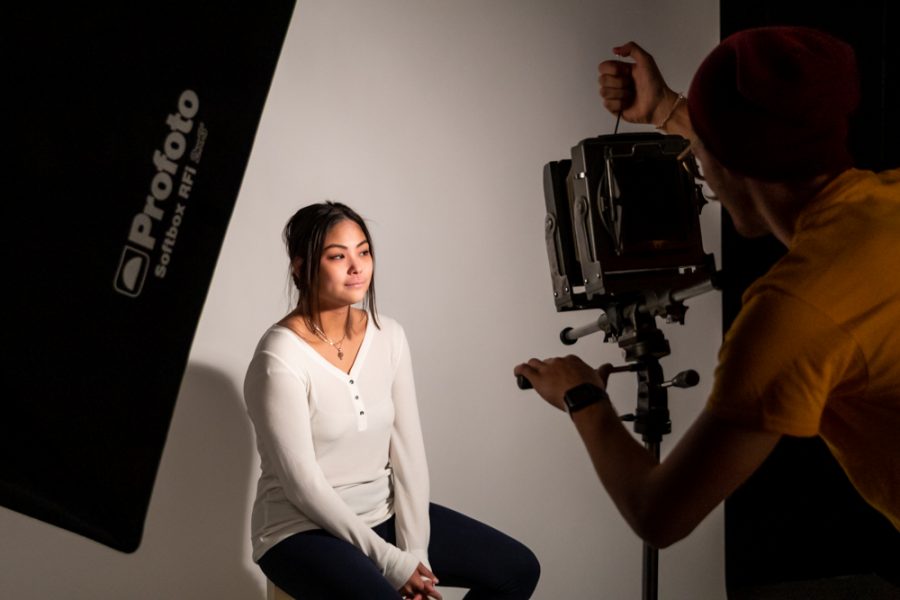 Bo Russell in the lighting studio using a 4x5 view camera to capture portraits of Cyra Oh. 