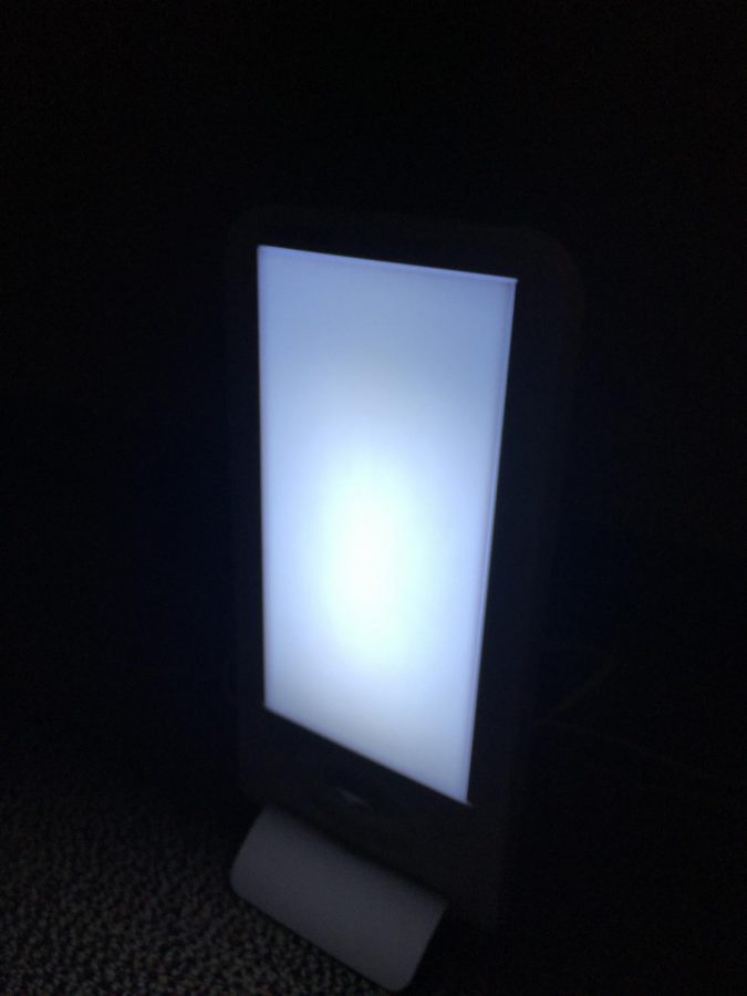 A light therapy lamp shining brightly in the Wellness Services office.