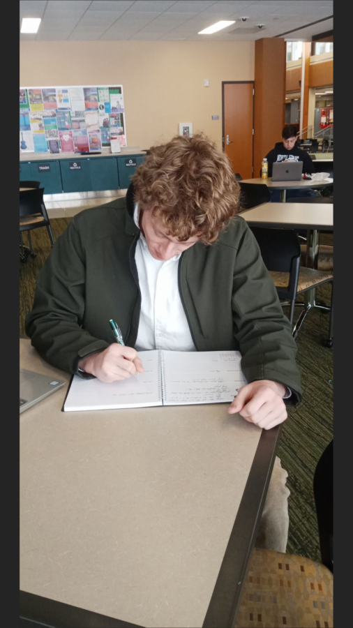 A student, Kian Madden, writing down the date of the Illinois Primary date, March 17.