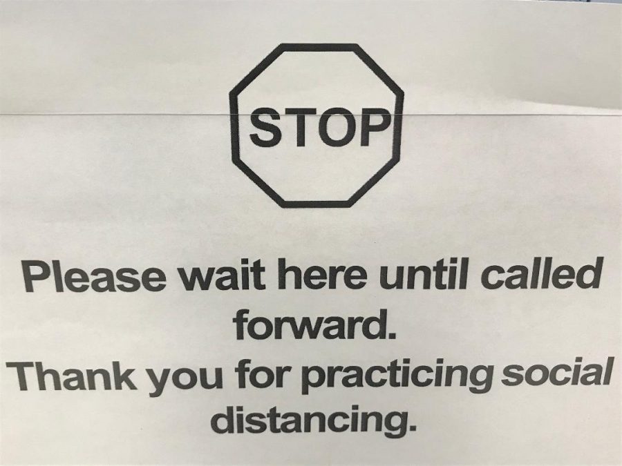 Signs warning people to practice social distancing in grocery stores became widespread in mid March.