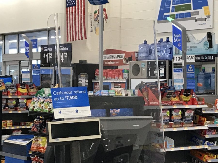 Big box retailers including Walmart installed sneeze guards to separate the customers from the cashiers.