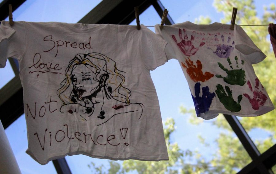 T-shirts with messages about domestic violence awareness on them.