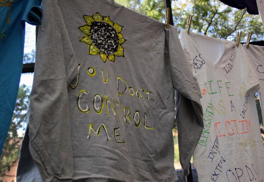 T-shirts with messages about domestic violence awareness on them.