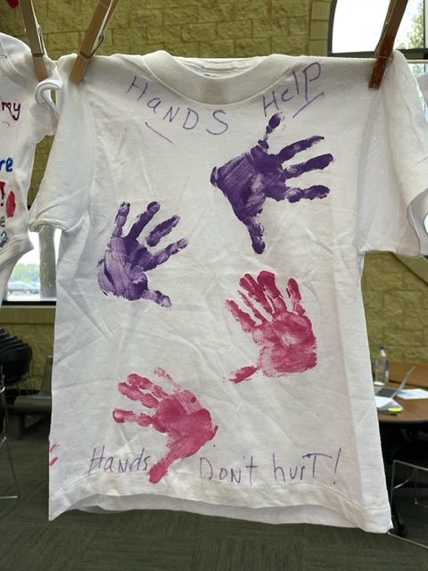 A t-shirt with a message about domestic violence awareness written on it.