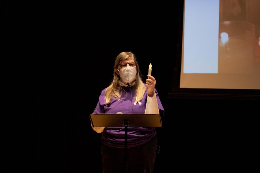 Domestic Violence Team Community Educator, Ruth Peterson, holds up candle as she honors victims of Domestic Violence on Oct. 28. 