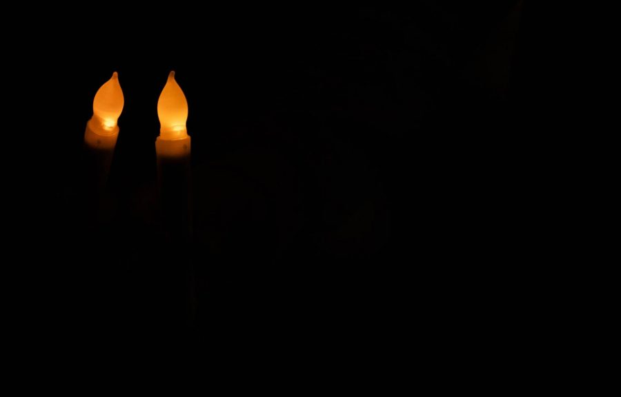 Two candles shine during the candlelight vigil for the end of Domestic Violence month on Oct. 28. 