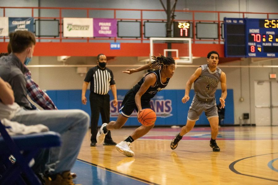 Guard, Dorien Little dribbles the ball against Judson University on Nov. 8. As of Nov. 21, the Spartans have a 3-2 record.