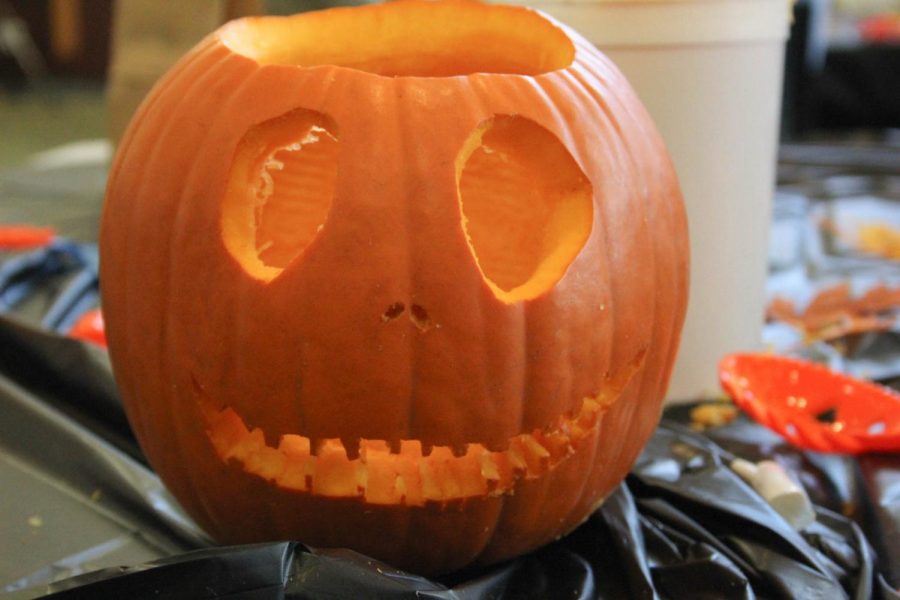 A pumpkin is carved to look like the character Jack Skellington from The Nightmare Before Christmas.
