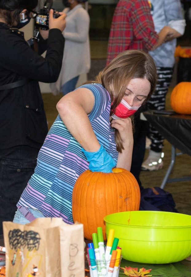 Fall Fest participant scoops out the inside of a pumpkin on Oct. 27. 