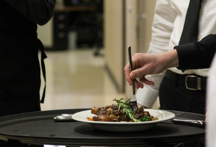 Service management tries the Moroccan Lamb and Apricot Tagine before approving it for the restaurant. 