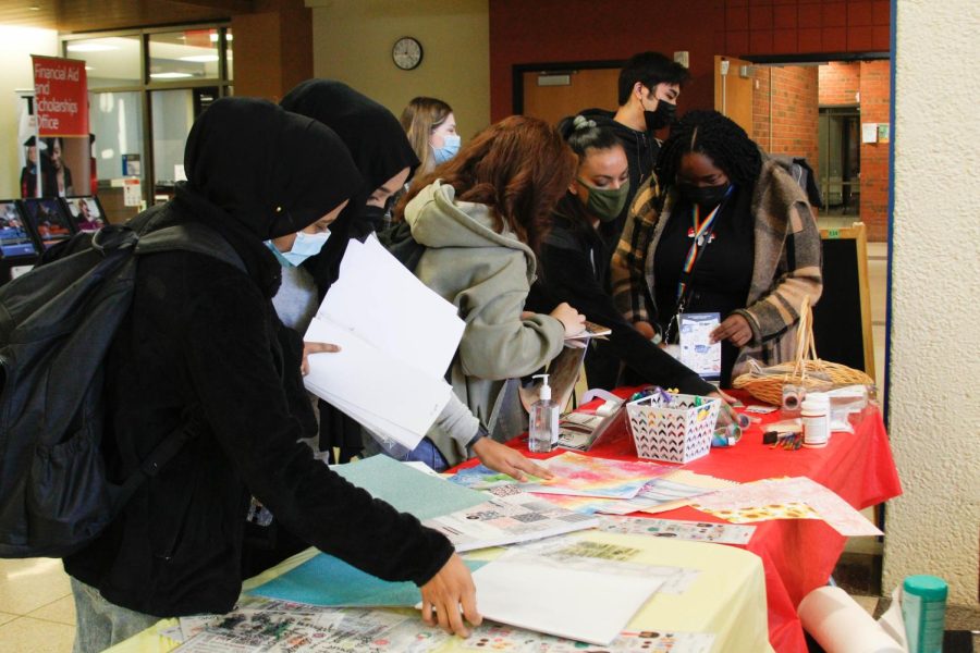 Students look through craft items to create self-care journals at Creativi Tea.