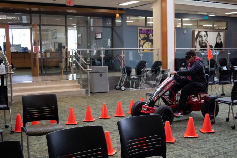 A student drives a Go Kart while wearing drunk buster goggles on April. 20. 