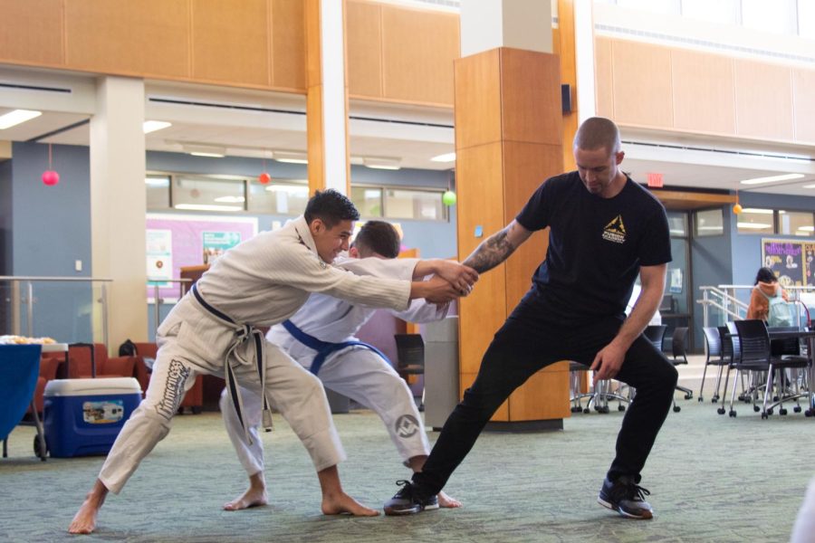 Ian Alexander of Fusion Academy of Martial Arts teaches self defense techniques with Hector Salazar on April 19. 