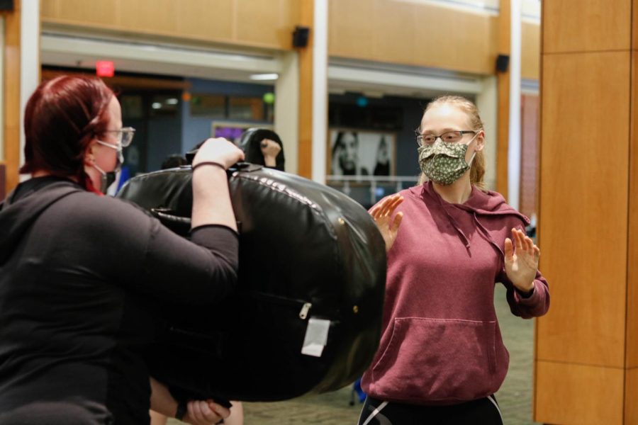 Participants work on a self-defense move from the class Apr. 20.