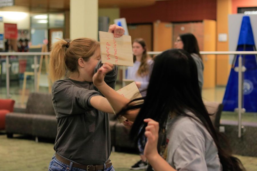 Participants work on a self-defense move from the class Apr. 20.