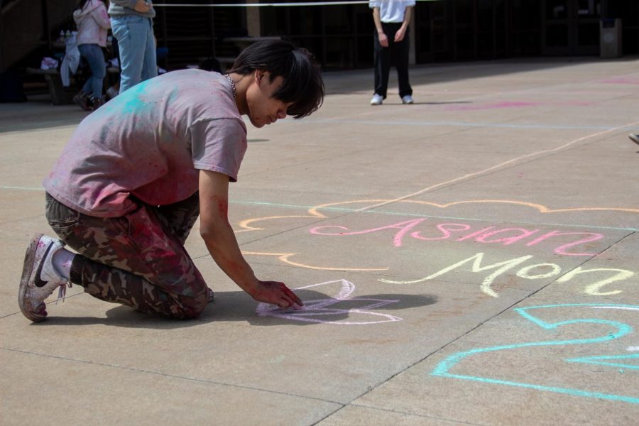 A student draws with chalk art at Asian Pacific Month celebration on May 4.