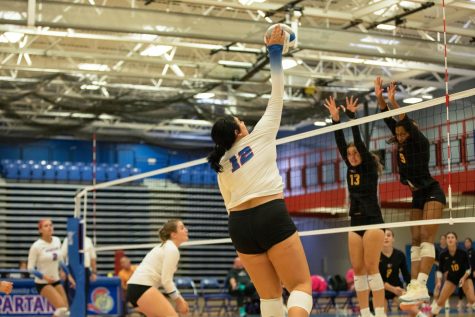 Middle blocker Ryann Mitchell (12) spikes the ball during the home match against McHenry County College on Wednesday, Sept. 14, 2022. 