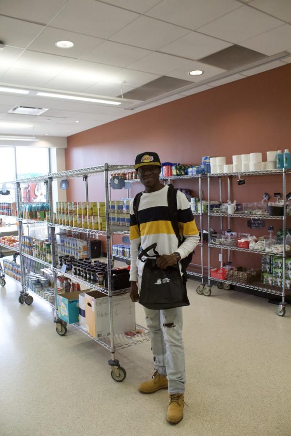 ECC second-year student Brian Awosika shops for food and goods at the Spartan Pantry on Oct. 21, 2022. 