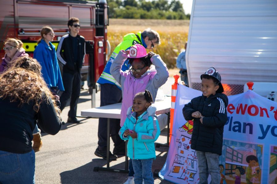 Layla Williams (8), left, Ze’ahna Williams (3), middle and Bryson Williams (5) pose for a photo at the ECC Center for Emergency Services Open-House Event in Burlington on Saturday, Oct. 15, 2022. 