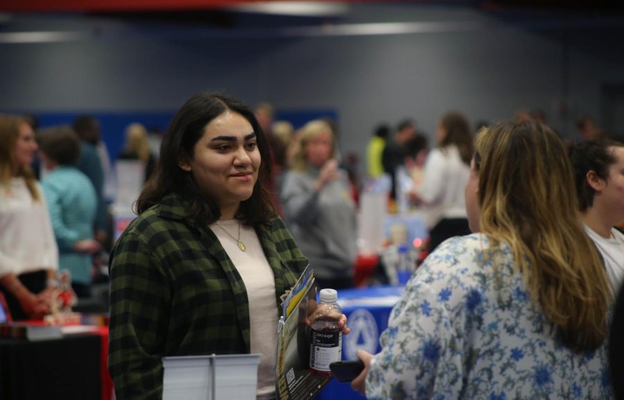 ECC student Margret Garcia talks to a representative from College Blackburn at College Night in Building J on Wednesday, Oct. 12, 2022. 