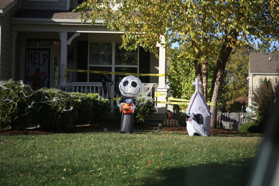 A Nightmare Before Christmas, spider webs, and caution tape decorate an Elgin house.