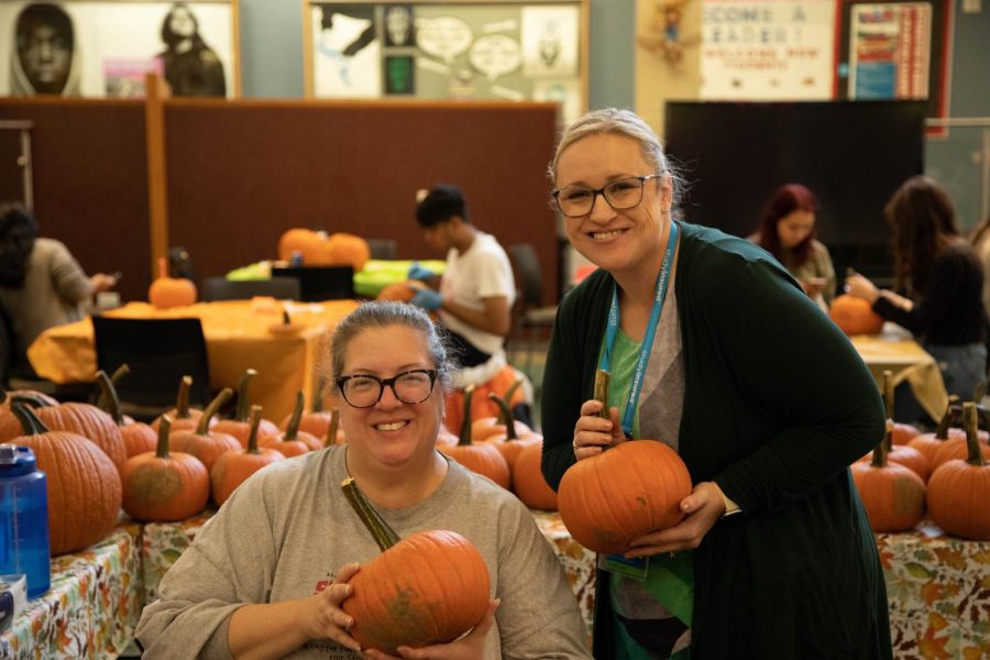 Director of Orientation and Student Life Amybeth Maurer, left, and Associate Dean Lauren Nehlsen hold up pumpkins at Fall Fest on Oct. 5, 2022. 