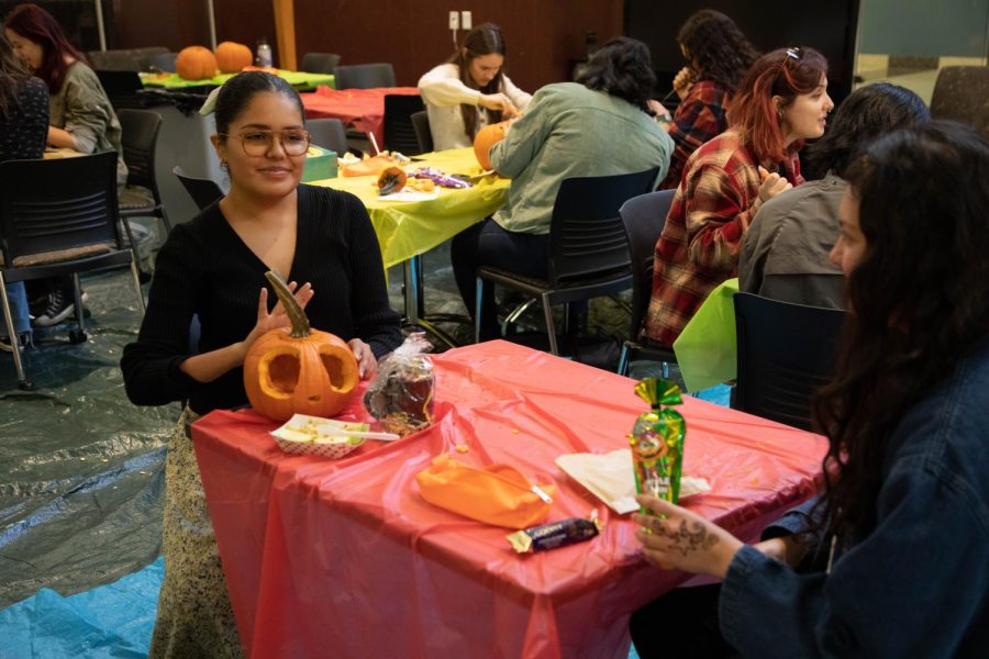 Students Diata Rodriquez (left) and Adilene Hernandez, right, talk while carving their pumpkins at Fall Fest on Oct. 5, 2022. 