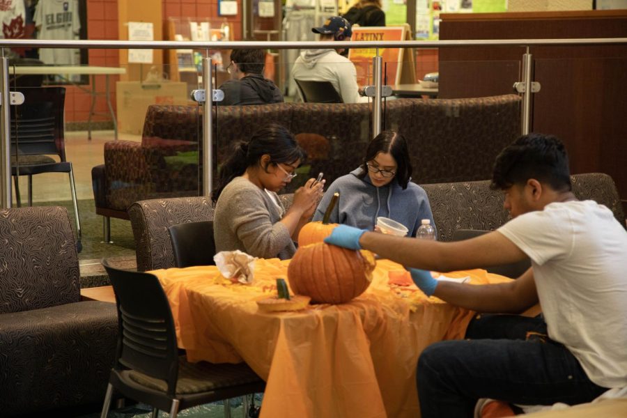 Fall Fest attendees carve pumpkins on Oct. 5, 2022. 