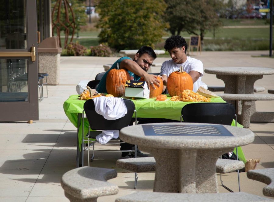 Students Javier Samaniego, left, and Uriel Garcia look at a pumpkin together at Fall Fest on Oct. 5, 2022. 