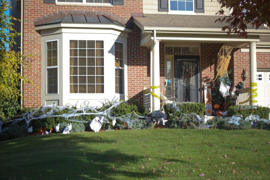 Spider webs and caution tape decorate an Elgin house.