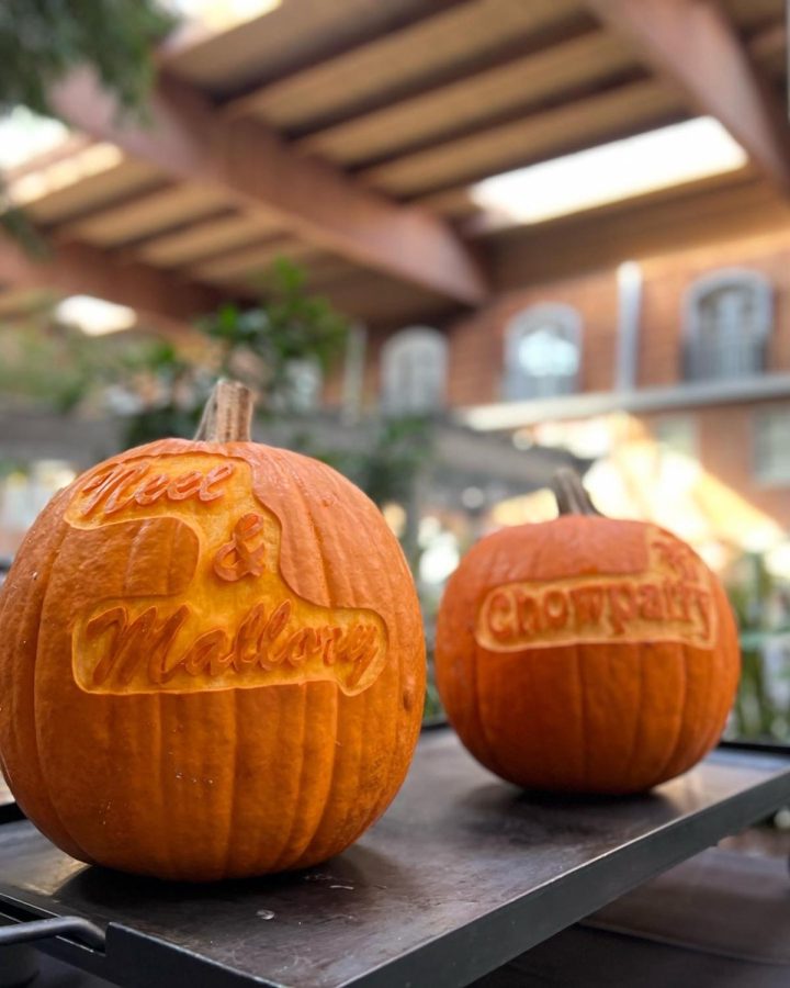 Pumpkins with an inscription reading Neal & Mallory, the names of the bride and groom sit on a table on Nov 26, 2022. 