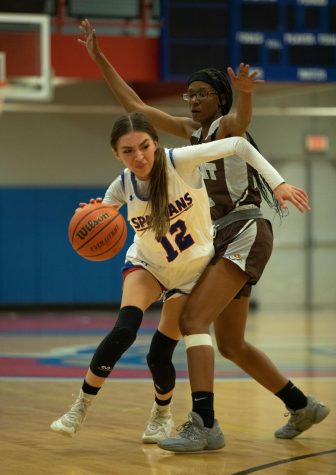 Guard Ari Franco (12) moves around defender Destiny Cox during a game against Wilbur Wright College  on Saturday Nov. 12, 2022. The Lady Spartans won the game 62-61 and their record is 2-6 as of Nov. 27, 2022. 