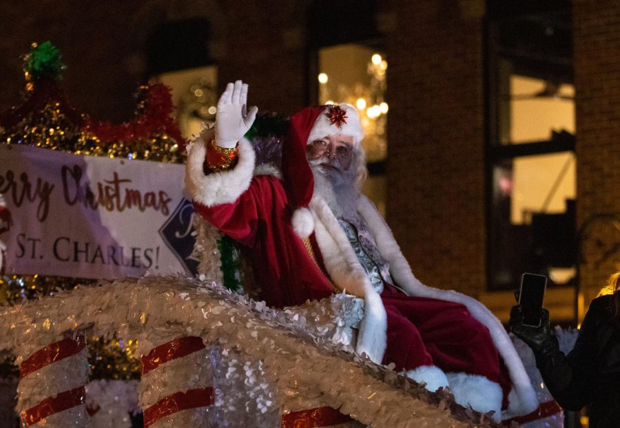 Santa waves from the top of a parade float during the St. Charles Electric Christmas Parade on Saturday Nov. 27, 2022.  