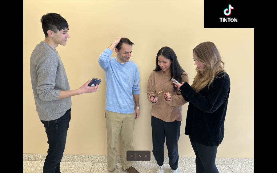 Members of the staff badger adviser Nick Obradovich to watch various TikTok videos. The Observer will be starting to post TikTok videos in the Spring 2023 semester! 
