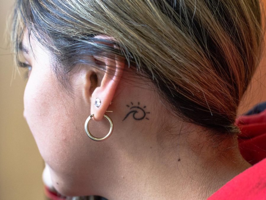 ECC student Roxana Perez shows off her beach wave tattoo located behind her ear.