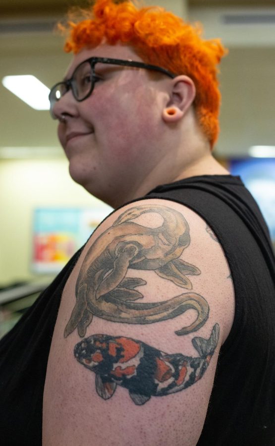 ECC student Roswell Howells shows off his symbolic and colorful Loch Ness monster and koi fish tattoo.