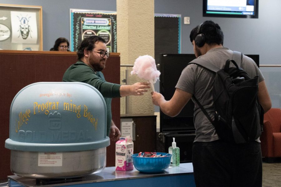First-year student Joseph Godinez Cardenas receives cotton candy in the Jobe Lounge on Feb. 7, 2023. 